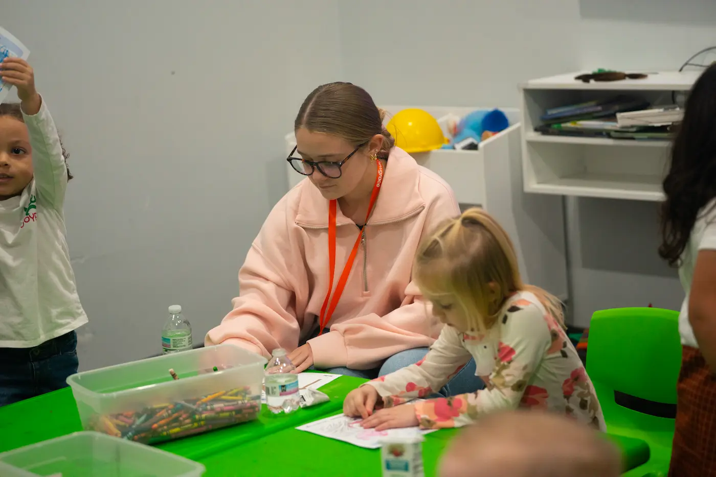 ngKid volunteer and child doing crafts.