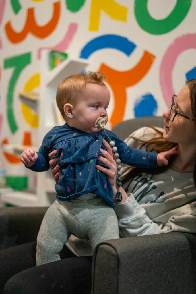 ngKids baby playing with volunteer.