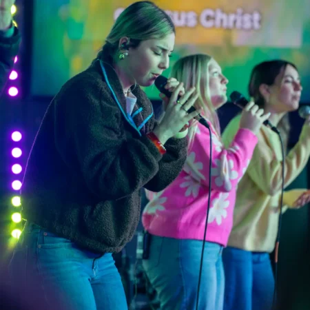 ngStudents worshiping on stage.