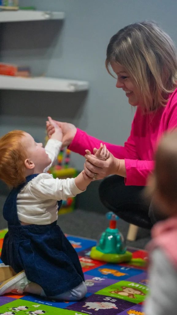 ngKid volunteer and child playing.